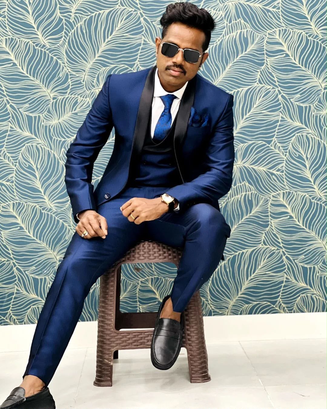 Amudhavanan seated in a blue suit